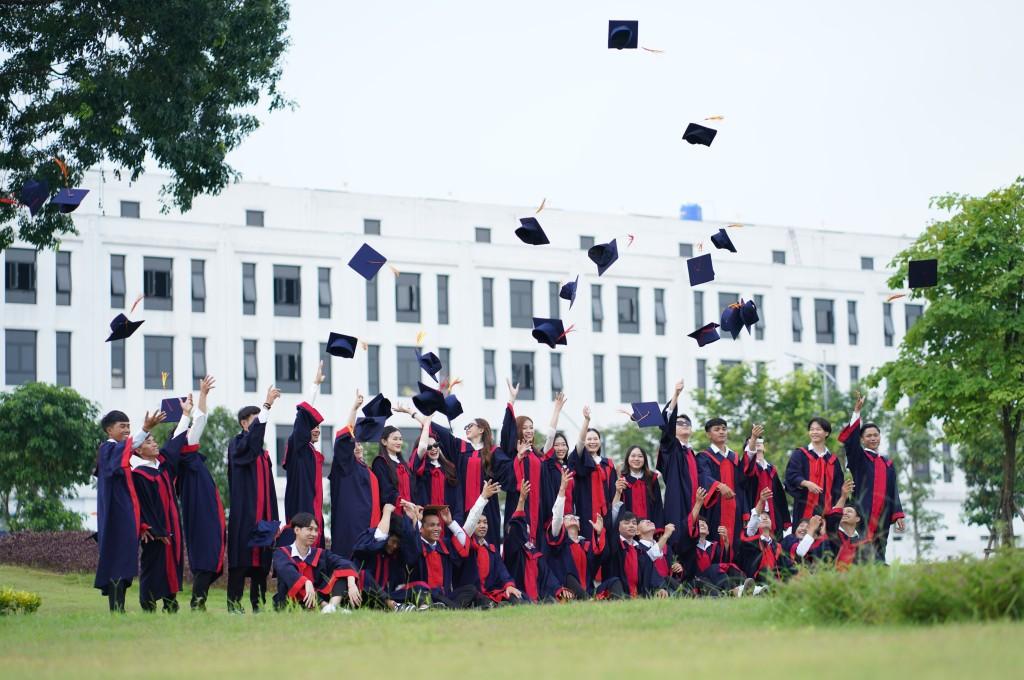 Graduates celebrating in caps and gowns